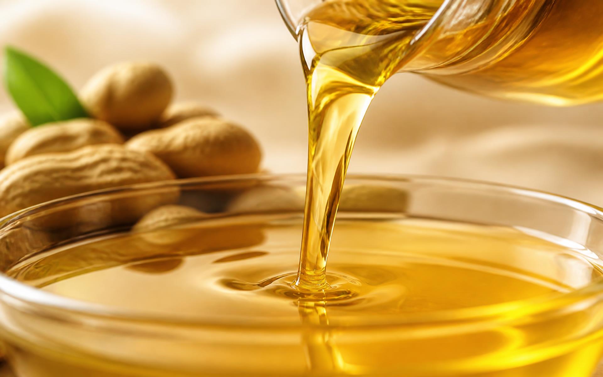 Golden groundnut oil being poured